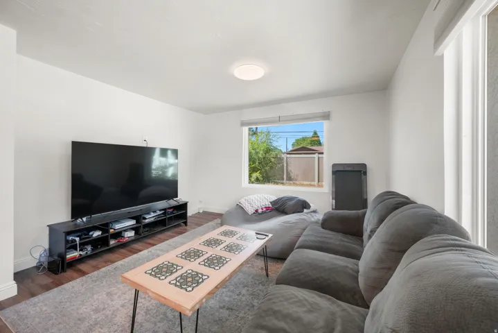 Spacious room with wood-finish flooring and neutral wall tones