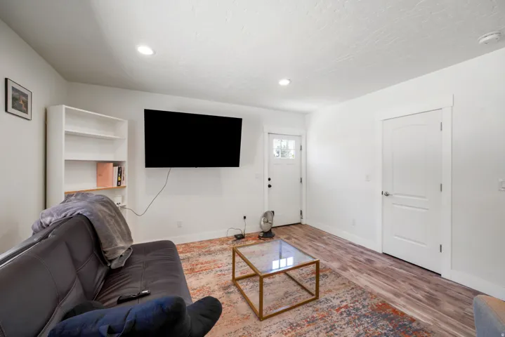 Bright living space featuring wood-finish flooring and recessed lighting