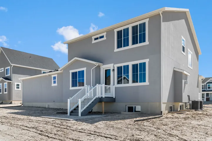 Contemporary two-story exterior with light gray stucco siding and white trim
