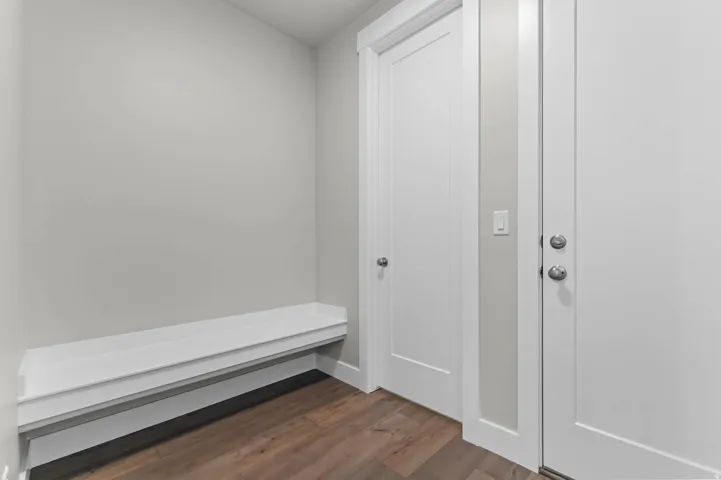 Built-in white bench seating paired with wood-finish flooring