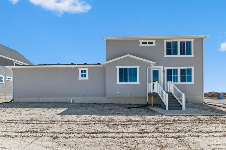 Contemporary exterior featuring grey stucco siding and white trim