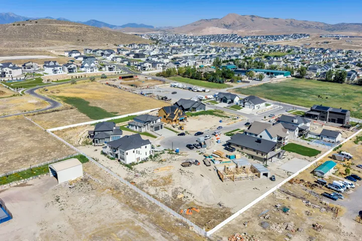 Residential development featuring a mix of completed homes, homes under construction, and undeveloped lots