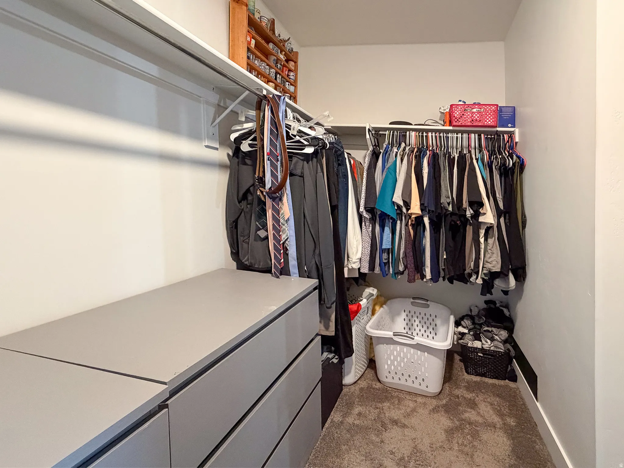 Custom closet with built-in shelving, hanging rods, and integrated drawer storage