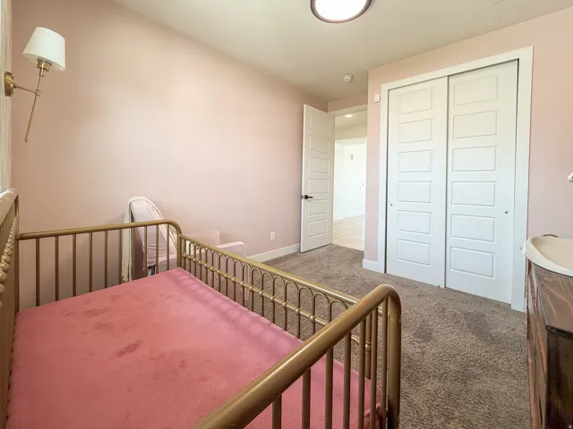 Recessed ceiling light fixture illuminating a room with soft pink walls