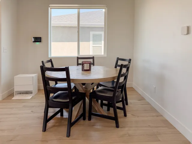 Light wood-finish flooring complements the neutral wall tones