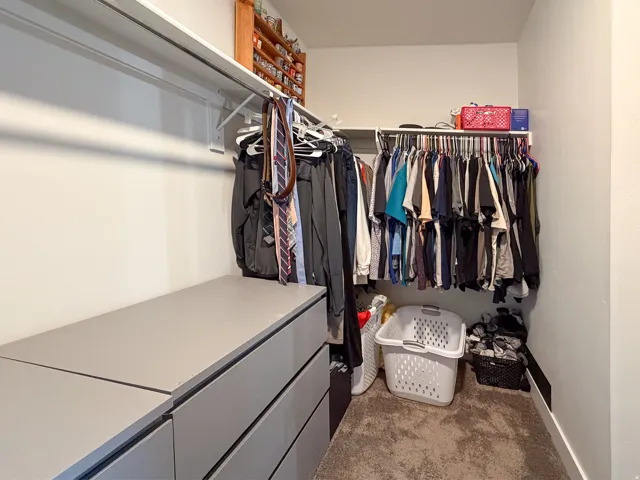 Custom closet with built-in shelving, hanging rods, and integrated drawer storage