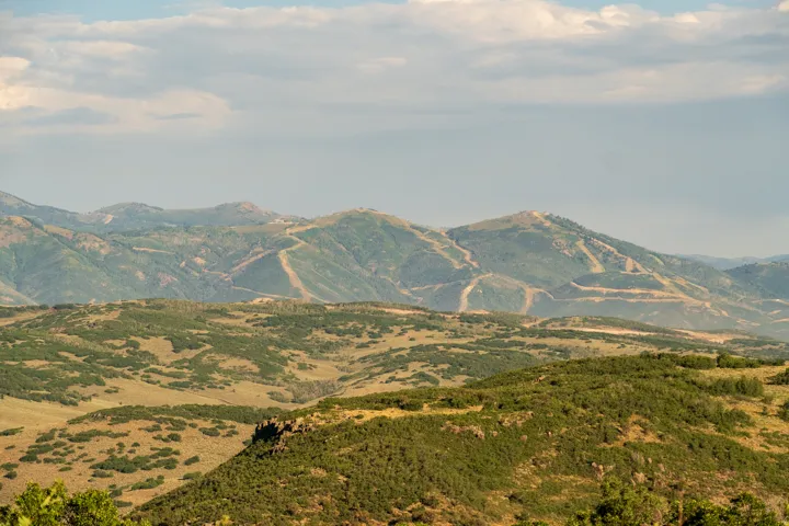 Expansive mountain landscape featuring varied terrain and distant peaks