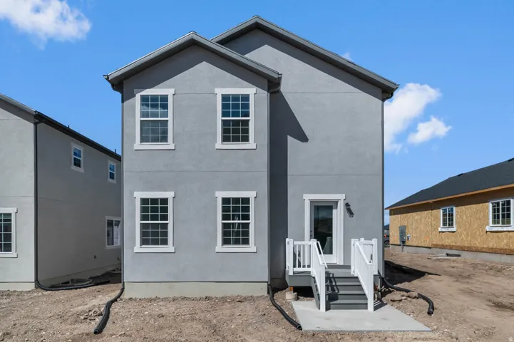 Gray stucco exterior with white trim details