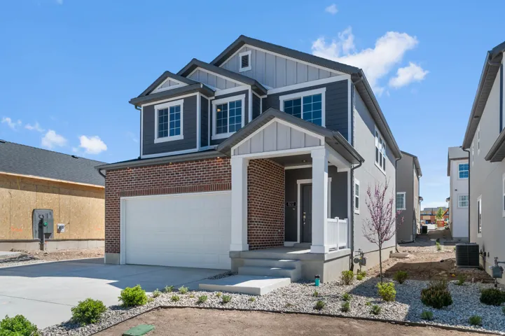 Contemporary-style residence featuring a two-story design with a brick and siding facade
