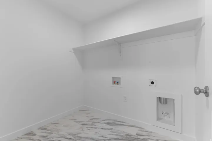 Laundry area featuring a built-in shelf, plumbing hookups, and a dryer vent