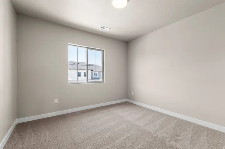 Neutral-toned carpeting paired with light walls and white baseboards