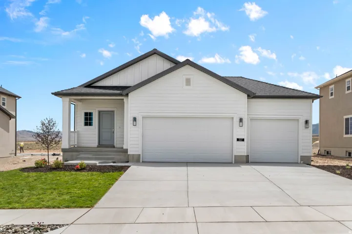 Contemporary single-story residence featuring white horizontal siding and dark gray roofing