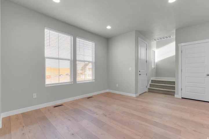 Living area featuring wood-finish flooring, recessed lighting, and neutral wall tones