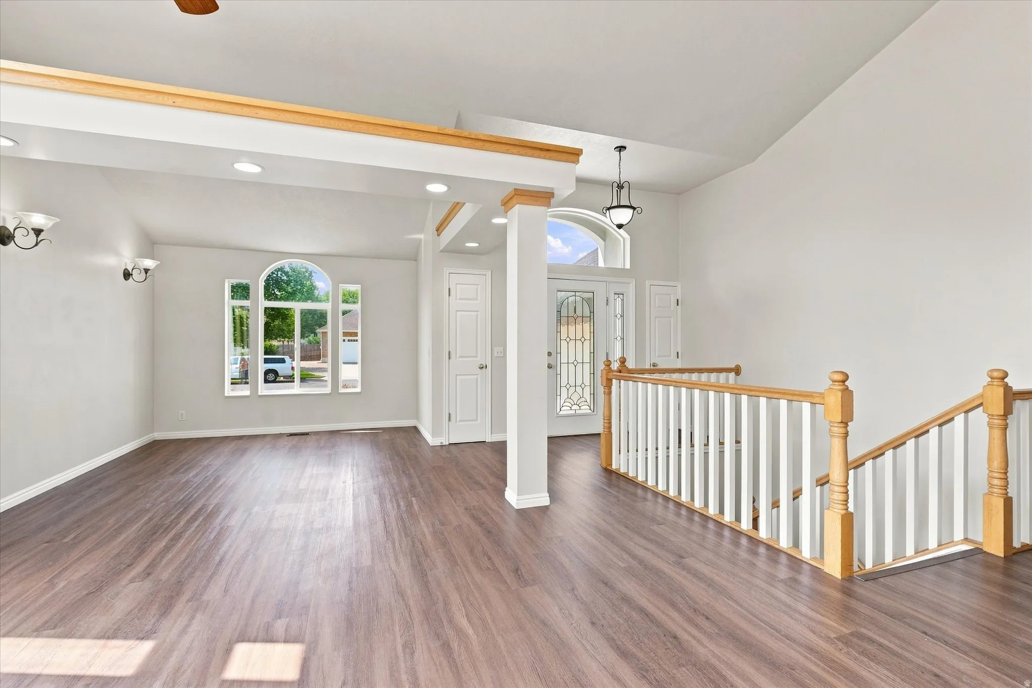 Spacious interior featuring vaulted ceilings and wood-finish flooring