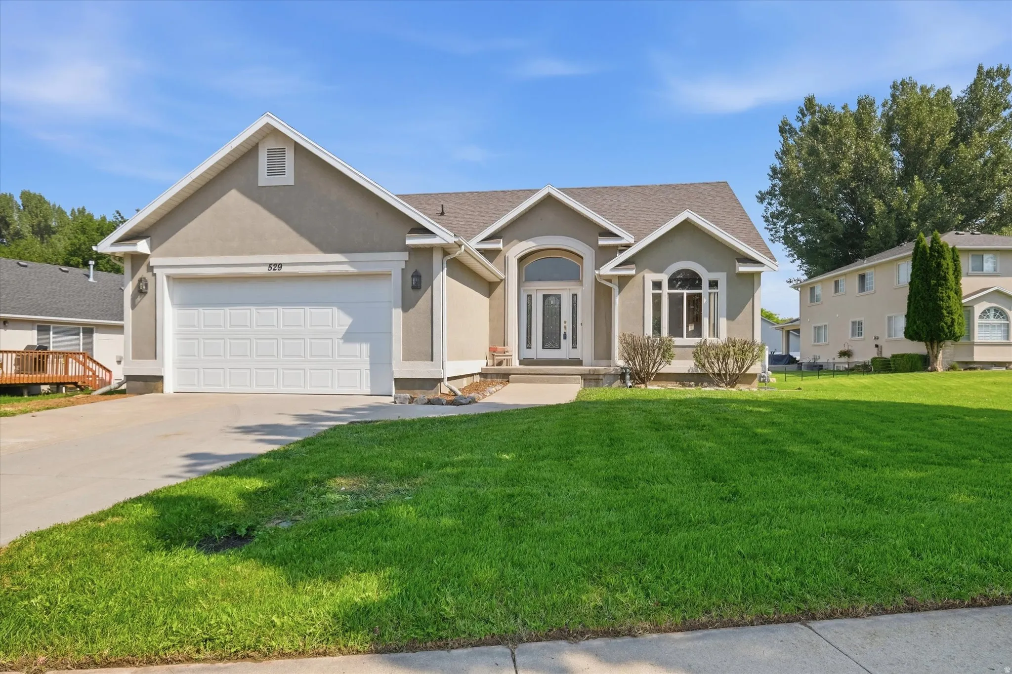 Stucco exterior with an attached two-car garage