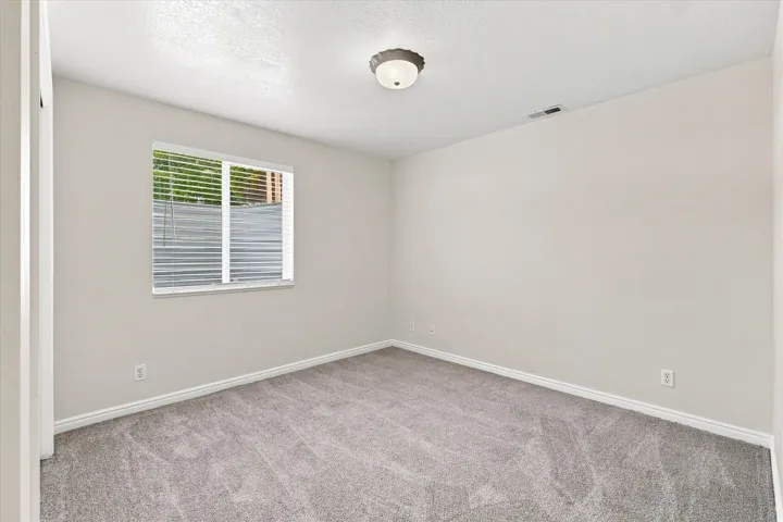 Light gray wall paint complemented by white trim and neutral carpeting