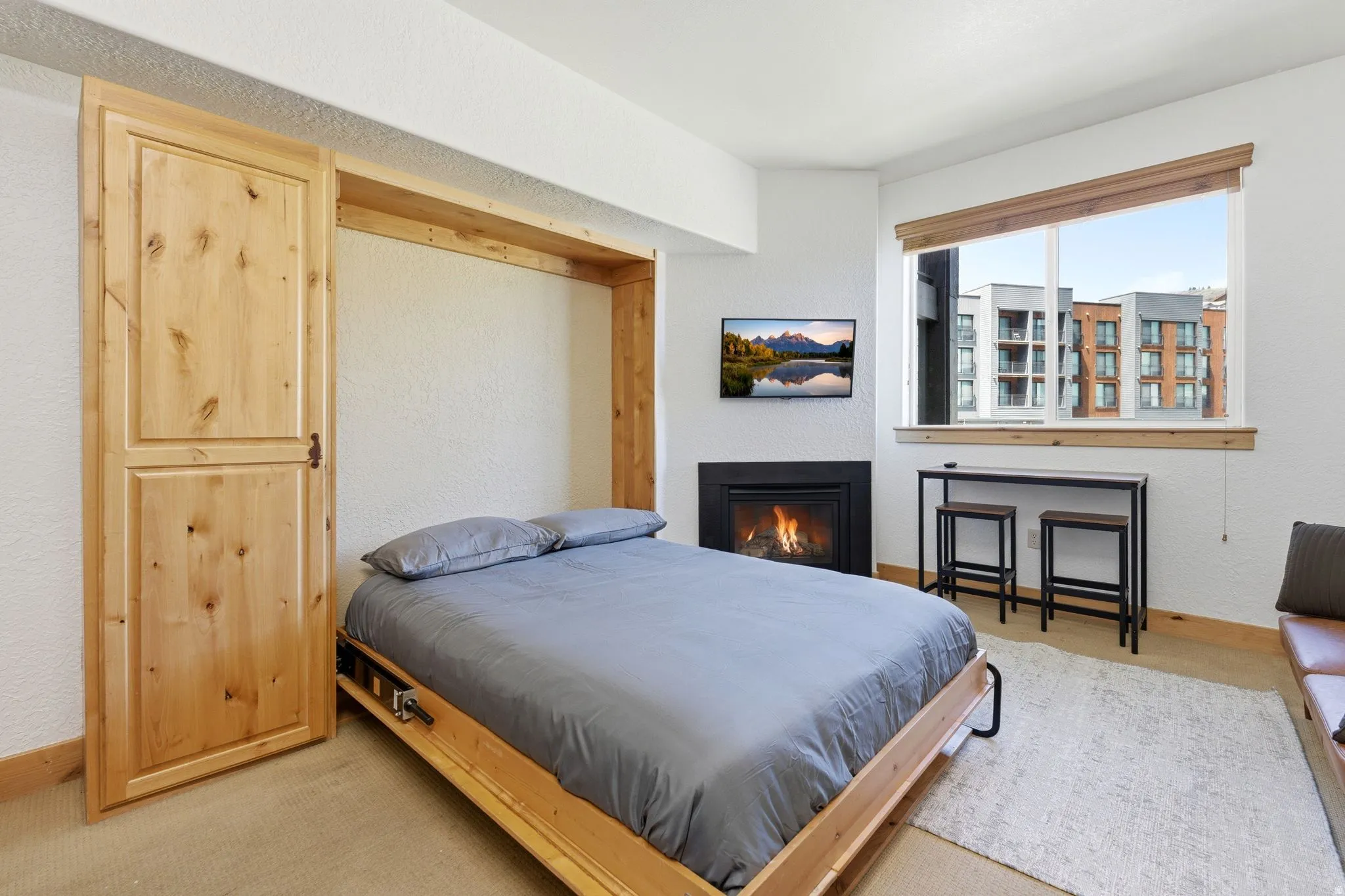 Built-in Murphy bed featuring natural wood cabinetry