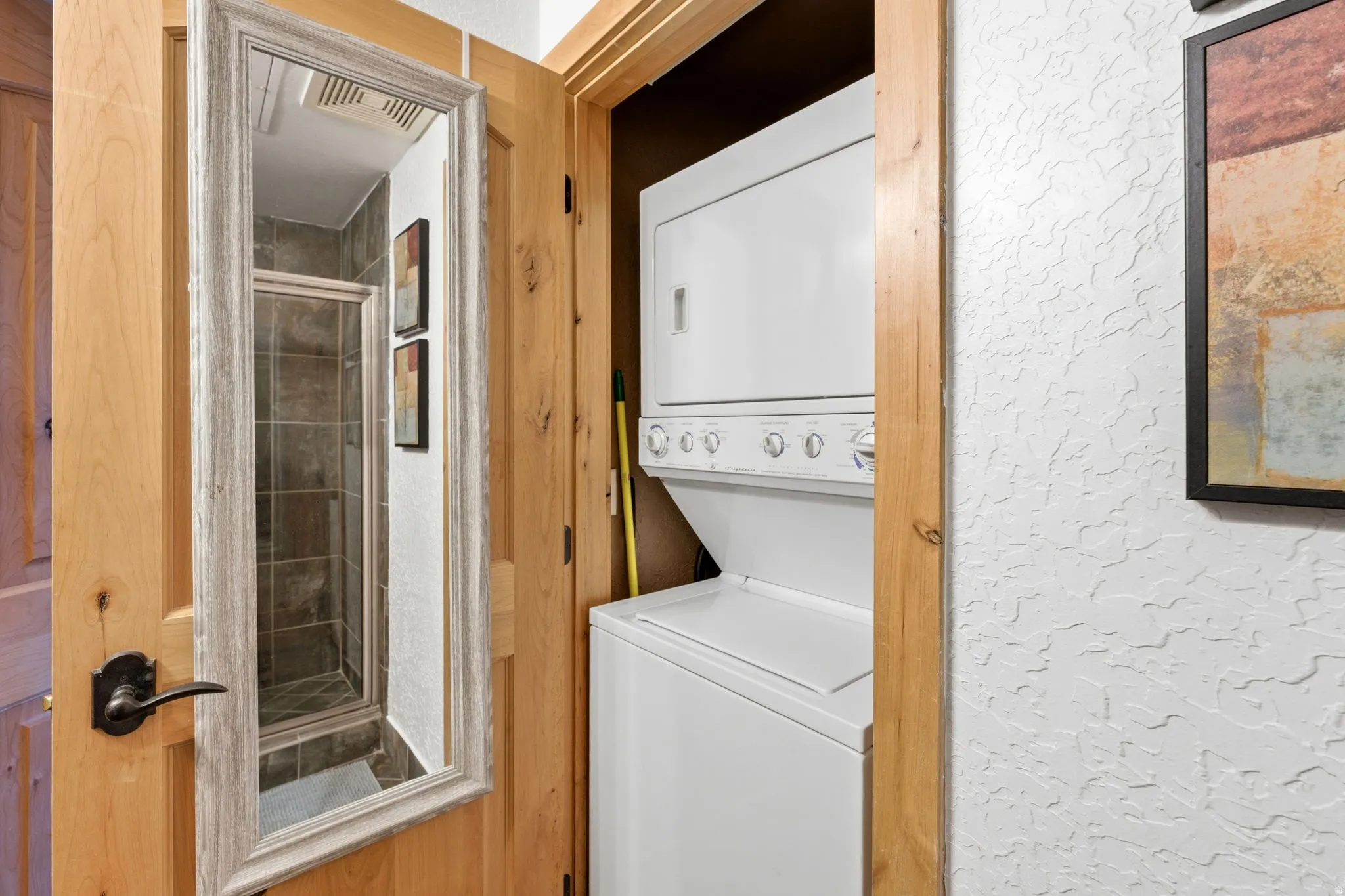 Stacked washer and dryer unit within a dedicated closet