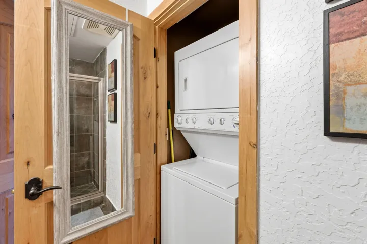 Stacked washer and dryer unit within a dedicated closet