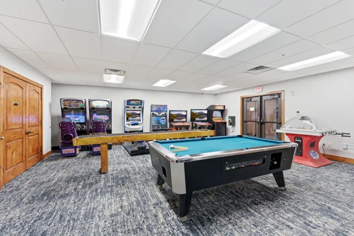 Recreational room featuring a pool table, carpeted flooring, white walls, and built-in ceiling light panels