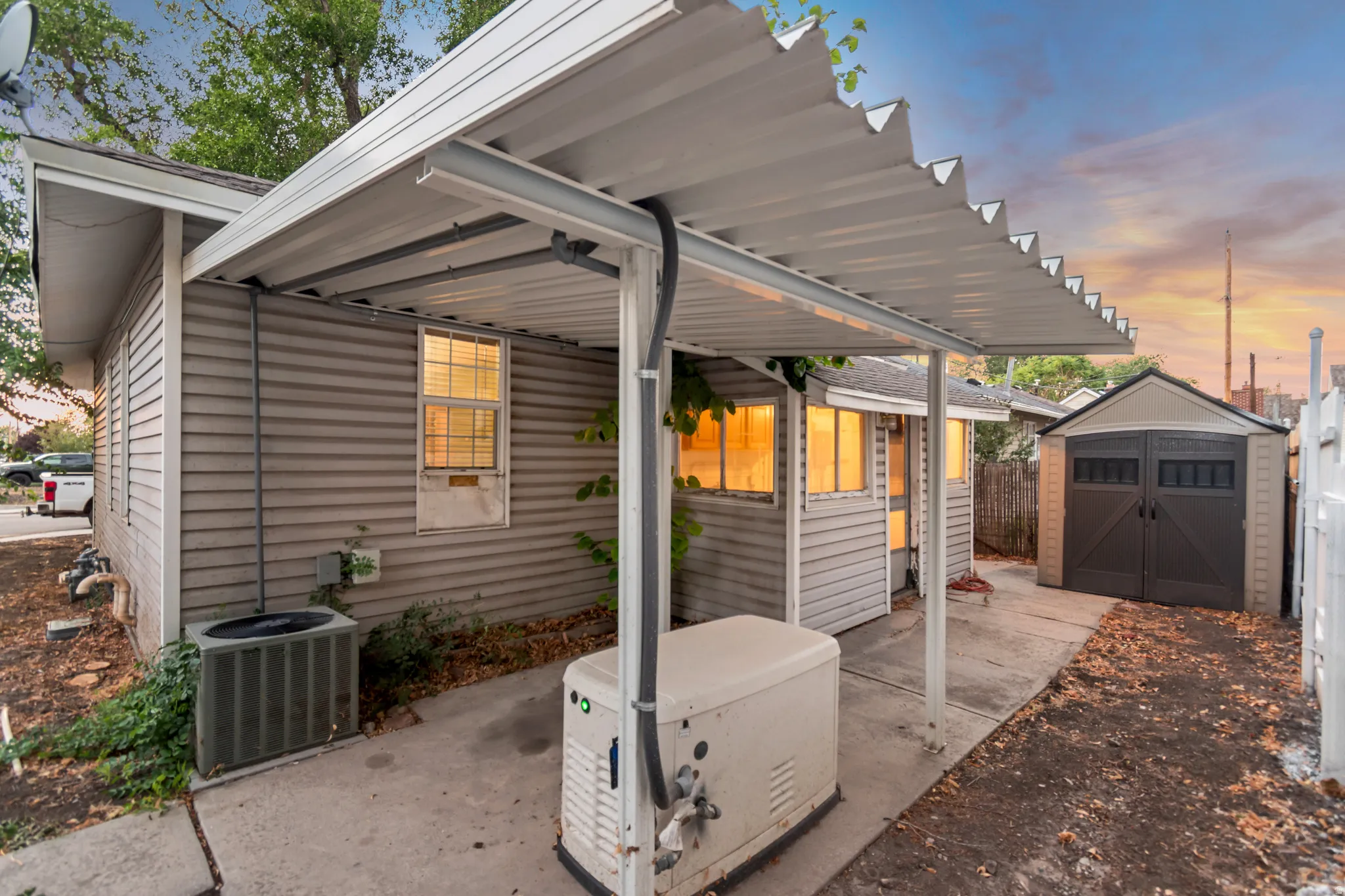Exterior siding with an overhead corrugated metal patio cover