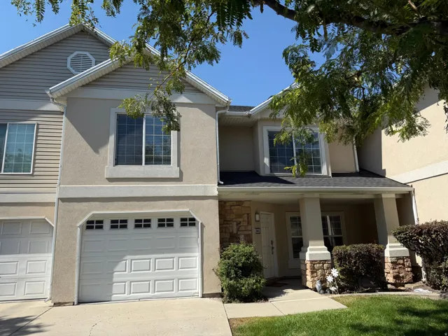 Townhome exterior featuring stucco and siding finishes