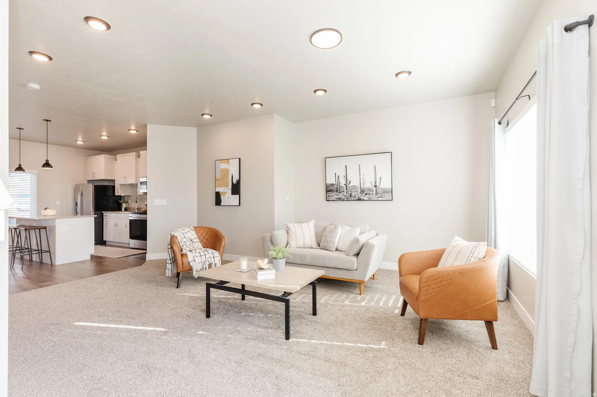 Open-concept living area with recessed lighting and neutral wall tones