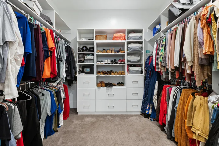 Custom closet system featuring extensive shelving, hanging rods, and integrated drawers