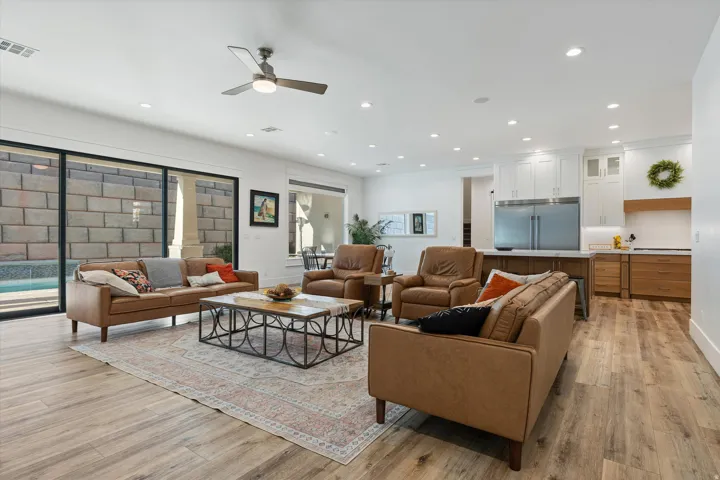Open-concept living space featuring wood-finish flooring, recessed lighting, and a ceiling fan