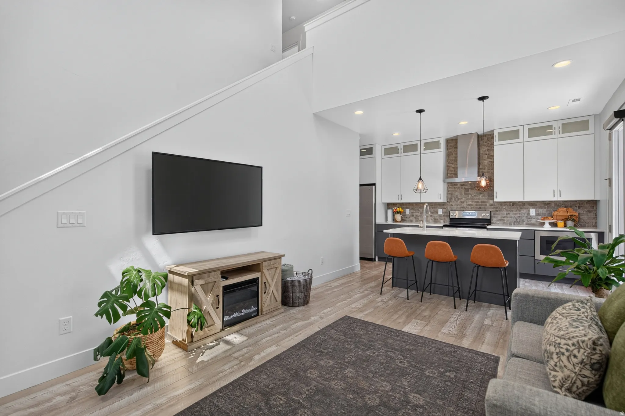 Open-concept living area with wood-finish flooring
