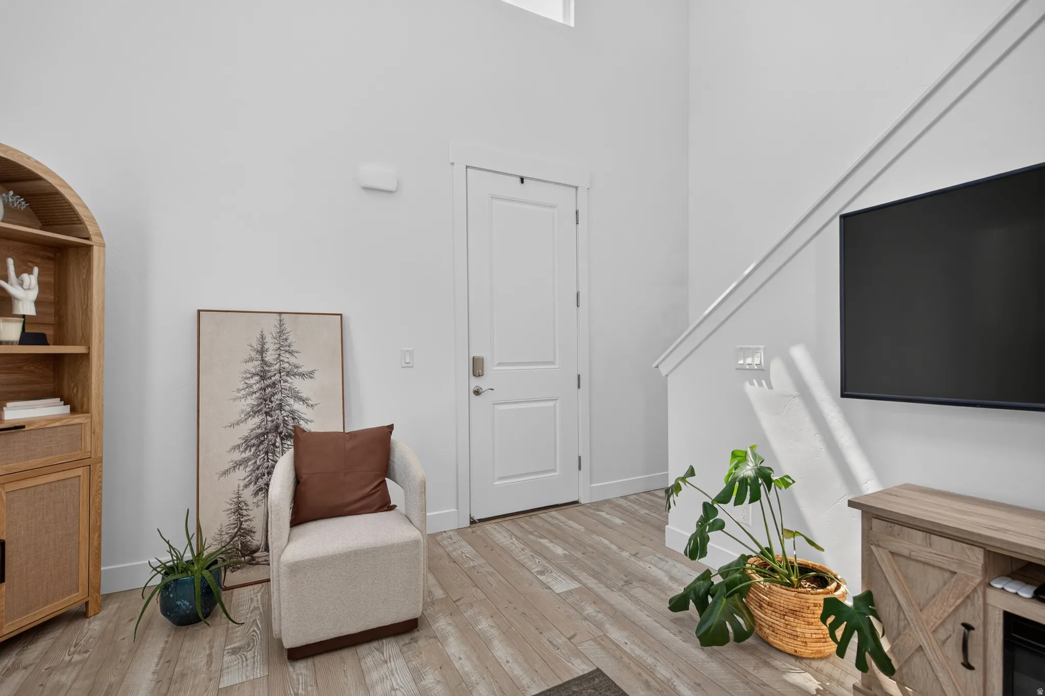 Vaulted ceiling with light wood-finish flooring