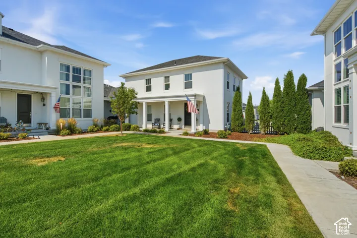 White stucco exterior with a covered front porch and columns