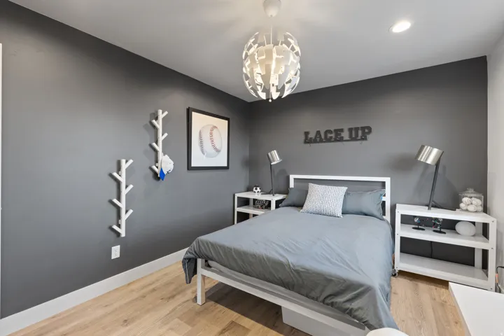 Bedroom featuring wood-finish flooring and a contemporary overhead light fixture