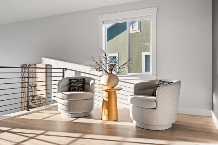 Upper-level landing featuring wood-finish flooring, a contemporary black metal horizontal railing, and abundant natural light from a prominent window