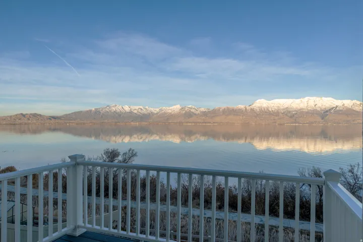 Balcony featuring white railing and blue decking