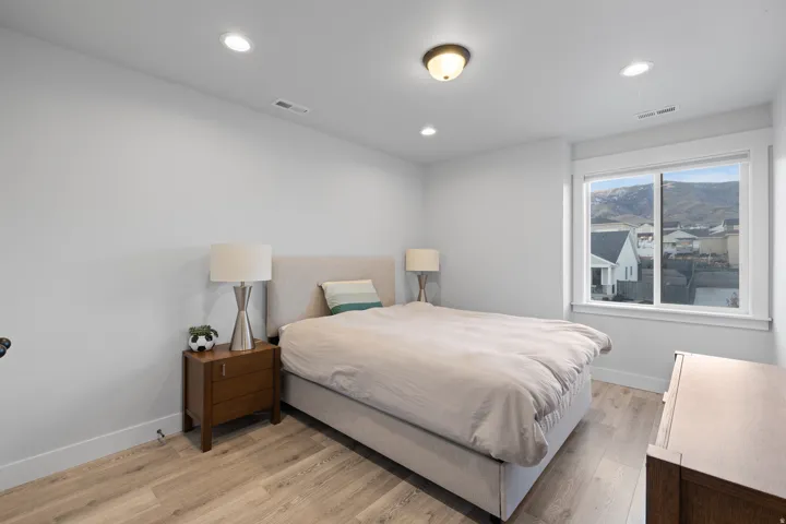Light-toned wood-finish flooring complements the neutral wall color