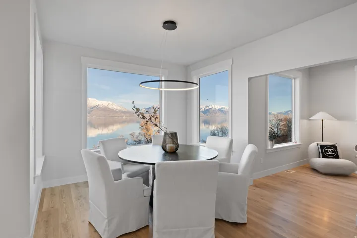 Dining space with large picture windows offering expansive water and mountain scenery