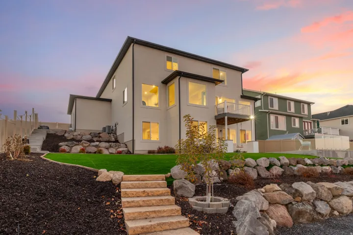 Modern stucco exterior with dark trim accents and abundant windows