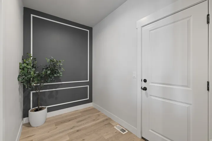 Accent wall with decorative molding and dark paint finish