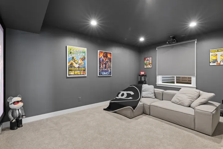 Dedicated media room featuring dark gray walls, recessed lighting, and a neutral carpet