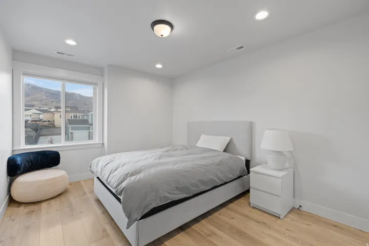Room featuring light wood-finish flooring, white walls, and recessed ceiling lighting