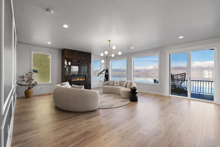 Spacious living area featuring expansive windows and a sliding glass door opening to a balcony