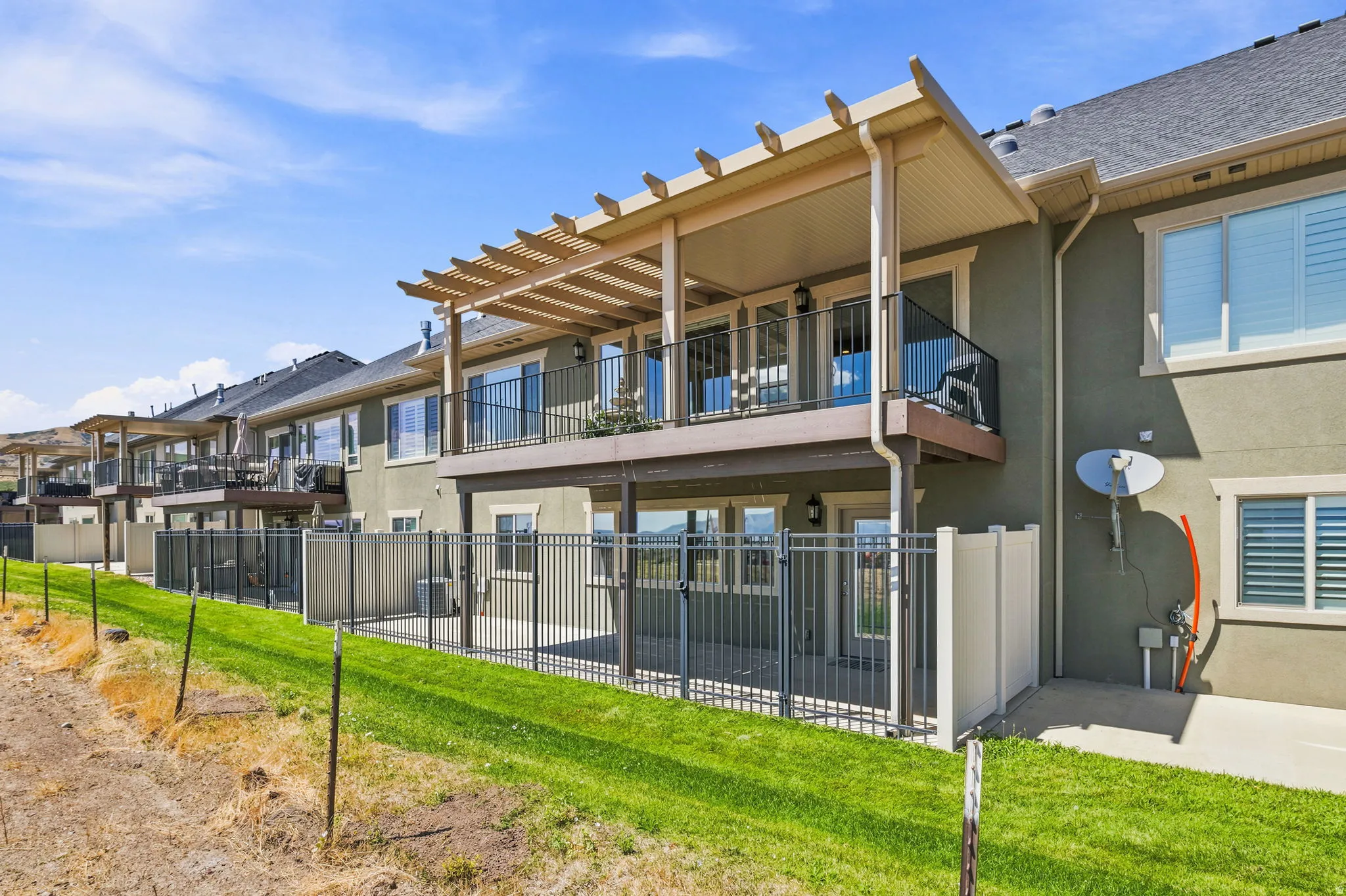 Rear exterior featuring a multi-level design with covered patios and upper-level balconies