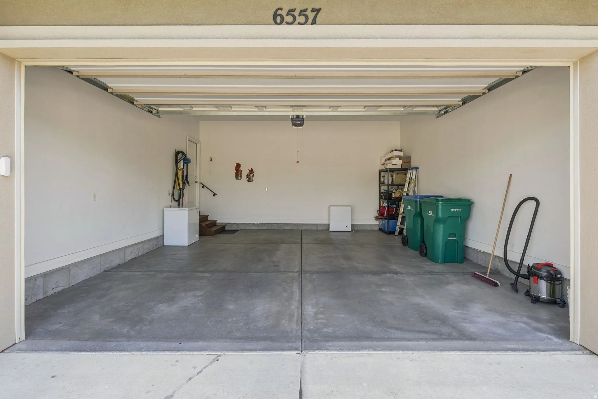 Spacious 2-car garage completely finished and painted with concrete flooring, an automatic garage door opener, and an interior access door.  Just a few steps to the kitchen.  Talk about  Convenient!