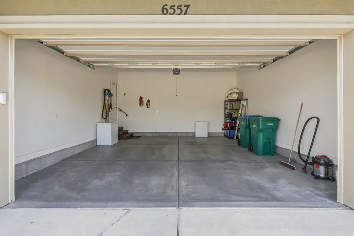 Spacious 2-car garage completely finished and painted with concrete flooring, an automatic garage door opener, and an interior access door.  Just a few steps to the kitchen.  Talk about  Convenient!
