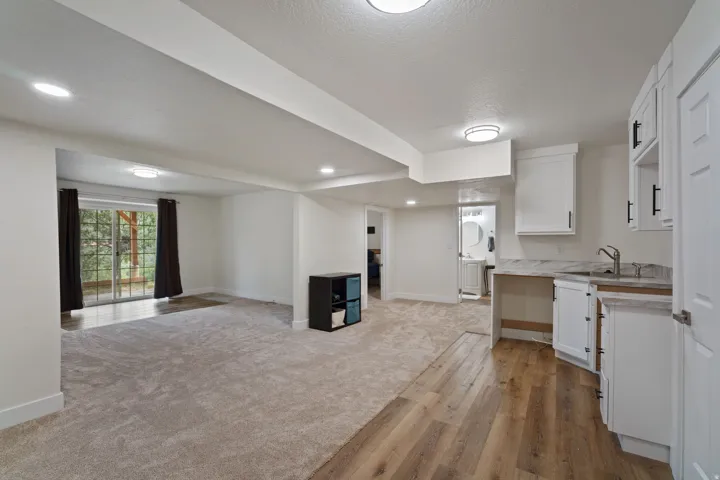 Open concept living space featuring recessed lighting and varied flooring