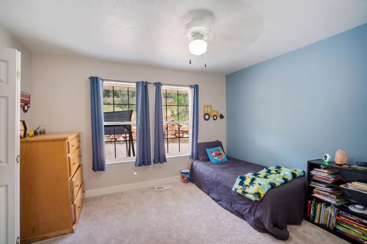 Room with light gray walls and a blue accent wall