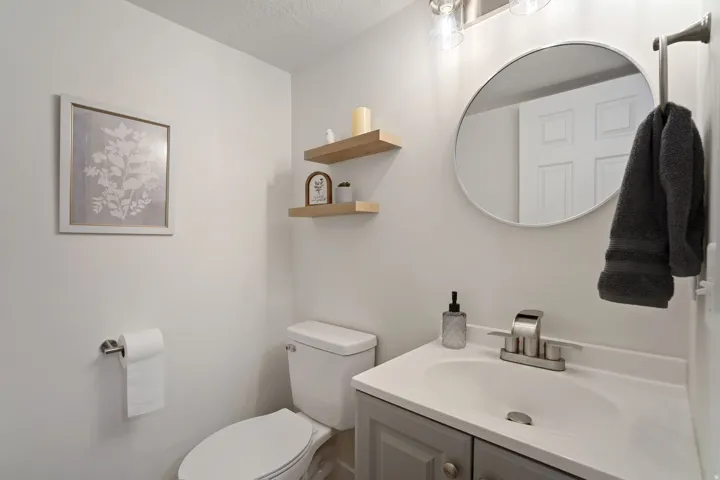 Bathroom featuring a light gray vanity with a white countertop and integrated sink