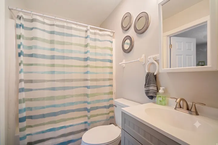 Bathroom featuring a white vanity with a built-in sink, brushed nickel faucet, and a wall-mounted medicine cabinet