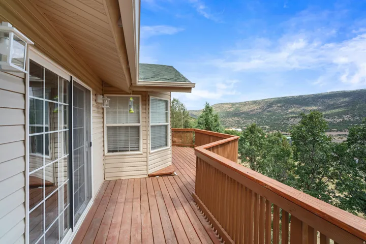 Expansive wood-finish deck with a mountain backdrop